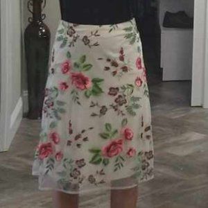 Light pink skirt with floral overlay